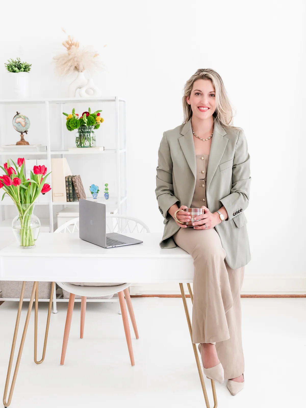 Molly Brazil, founding attorney of Brazil Family Law, seated on her desk in Winston-Salem